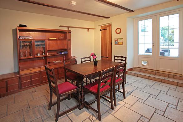 Interior of Rose Cottage: Dining
                  area, utility room and conservatory