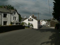 Threlkeld village main
                  street, with Rose Cottage and the Horse & Farrier
                  pub
